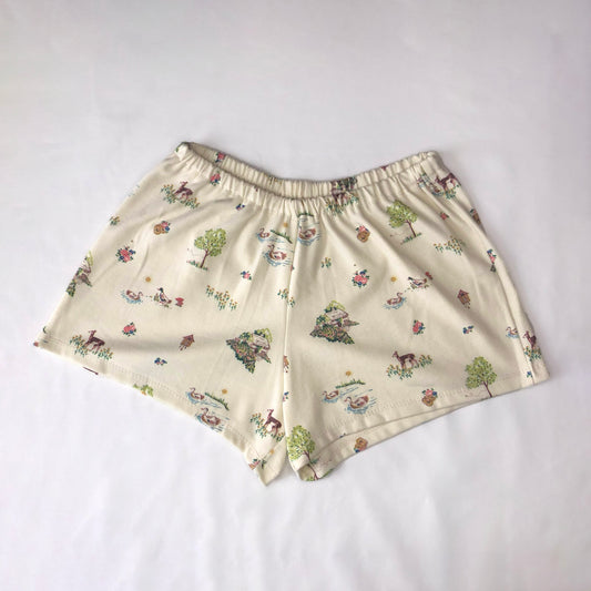 a cream lounge short featuring cottagecore motifs like ducks, fawn, and ditsy florals.