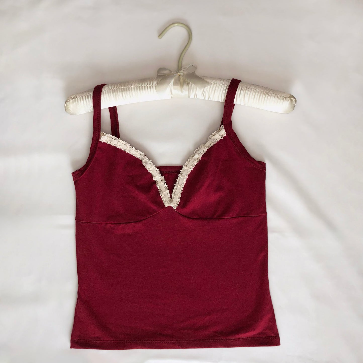 cute cami in a wine color. has a lace trim along the neckline.